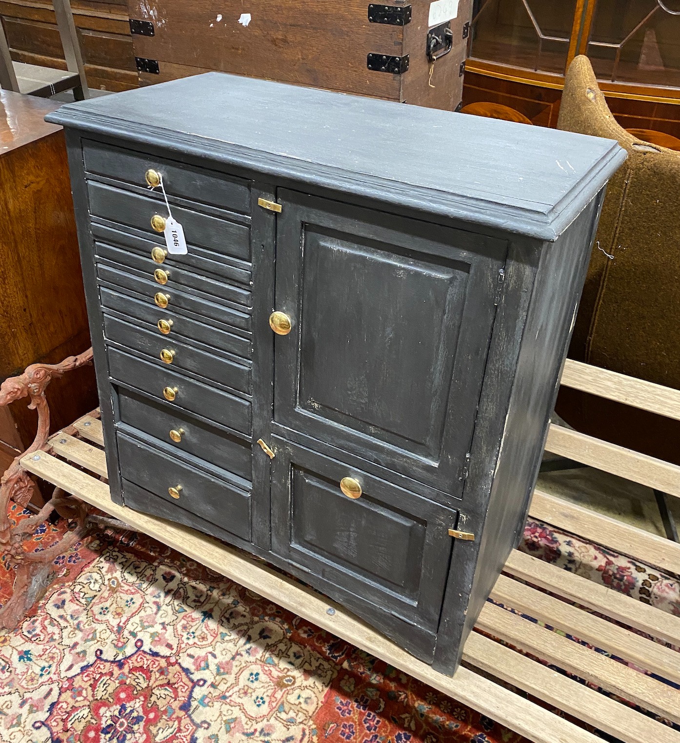 An early 20th century grey painted dentist's cabinet with nine drawers, a slide and two cupboards, width 77cm, height 78cm